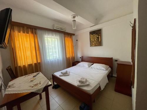 a bedroom with two beds and a window at Bar-Restaurant-Hotel River in Këlcyrë Fshat