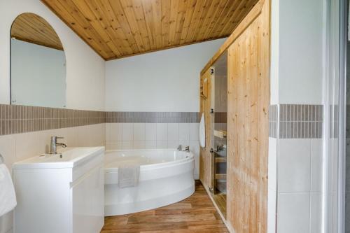 a bathroom with a white tub and a sink at Field View 1 bed-No Pets-Cedar in Eye