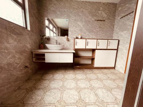 a bathroom with a sink and a mirror at Villa KimAnh in Sóc Sơn