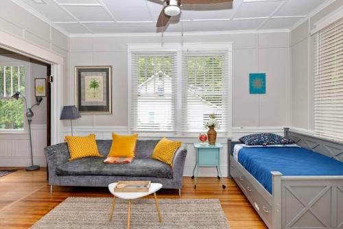 a bedroom with a bed and a couch at Century-Old Remodeled Splendor in Salisbury