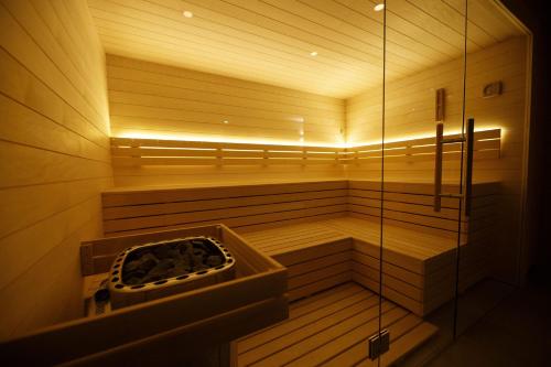 a sauna with a shower and a tub in it at Lázeňský hotel Pyramida in Františkovy Lázně