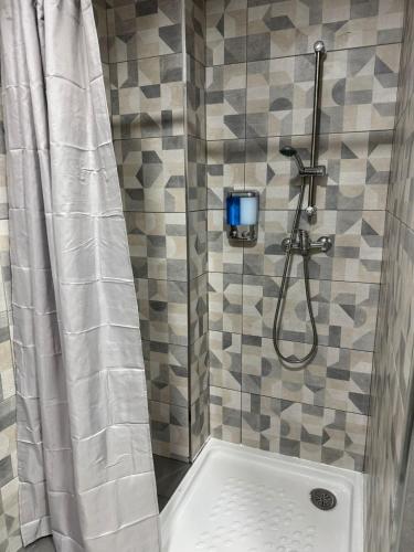 a bathroom with a shower with a shower curtain at Albergue el cristo in Porriño