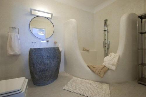 a bathroom with a large tub and a mirror at Chrysalis Nature Villa 8 in Kampos Paros