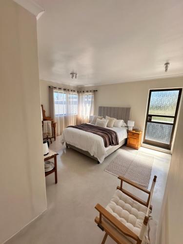 a large bedroom with a bed and a window at 95 on Acacia in Helderberg