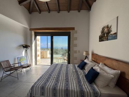 a bedroom with a bed and a view of the ocean at MayaElisa Villa with Heated Pool, By Hellocrete in Vamos