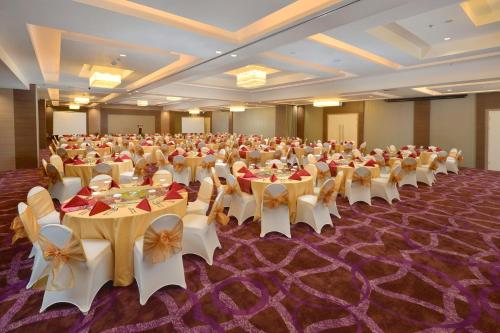 a large banquet hall with tables and chairs in it at Platinum Adisucipto Hotel & Conference Center in Yogyakarta