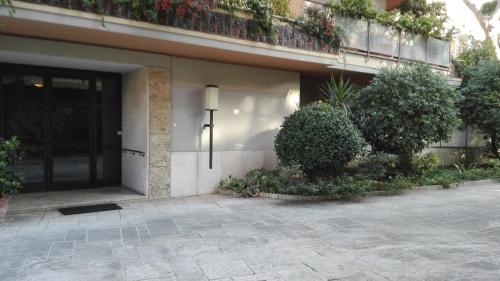 a building with a door and a balcony with plants at B&B Rome For You in Rome