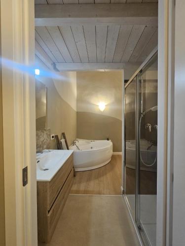 a bathroom with a tub and a sink and a shower at Aria di Mare - Tra Centro e Porto in Livorno