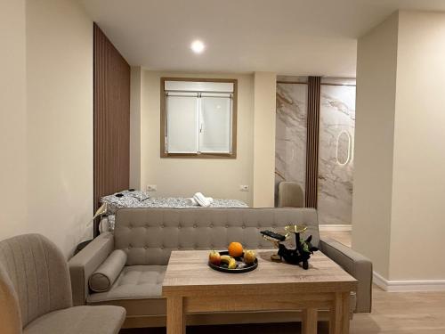 a living room with a couch and a table at Bianca Suites III in Bormujos