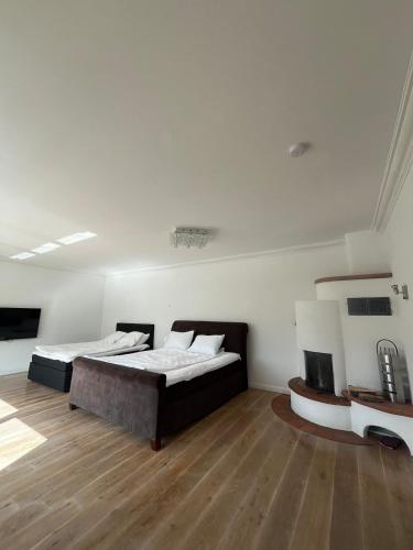 a bedroom with two beds and a wooden floor at Ferienwohnung Fatlume 2 in Bad Honnef am Rhein