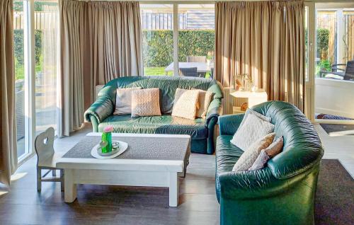 a living room with two couches and a coffee table at Oud Kempen Bungalow 183 in Stavenisse