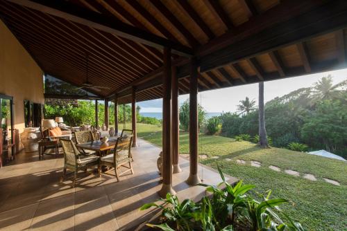 a patio with a table and chairs and a view at Cape Weligama - Relais and Chateaux in Weligama