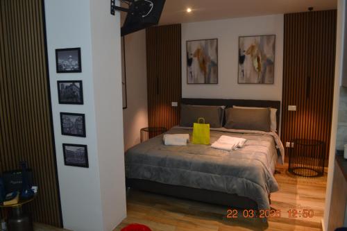 a bedroom with a bed with a yellow bag on it at Loft le Due Effe al Capo in Palermo