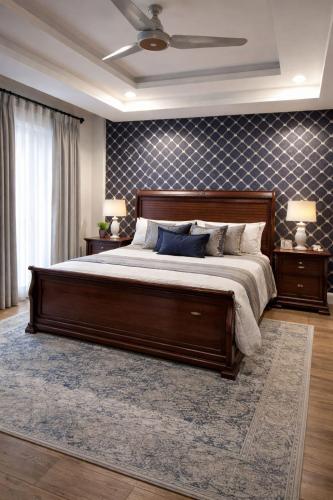 a bedroom with a large bed and two lamps at SmartStay Residences in Rawalpindi