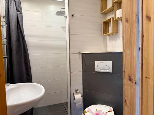 a small bathroom with a sink and a toilet at Bungalow Marita in Julianadorp