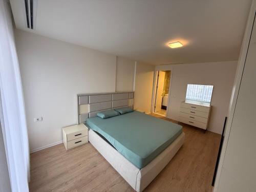 a small bedroom with a bed and a window at OMA Residence in Ferizaj