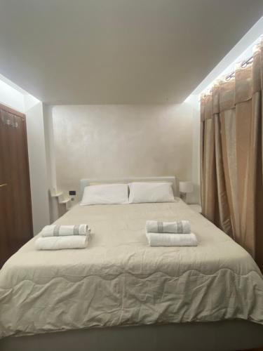 a bedroom with a large bed with two pillows on it at Casa Sole in Fenis