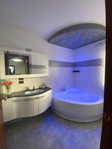 a bathroom with a large tub and a sink at Casa Sole in Fenis