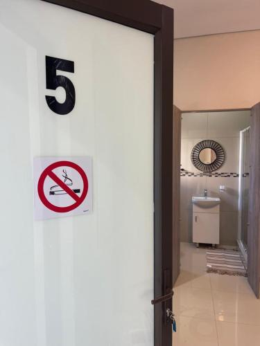 a number sign on a wall in a bathroom at Premium View Guesthouse in Windhoek