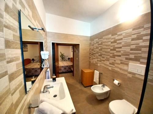 a bathroom with a sink and a toilet and a mirror at B&B "Sara" in Gemini