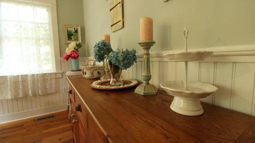 a room with a counter with a candle and a sink at Cutest Cottage On Central in Cape May Point
