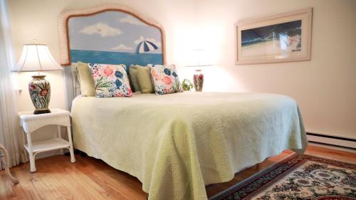a bedroom with a bed with a large mirror at The Sunset Hideaway in Cape May
