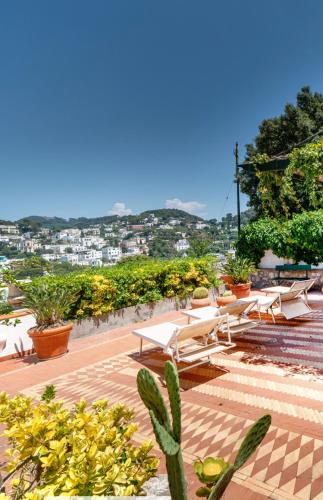 a group of chairs and tables on a patio at Villa Lyla in Capri