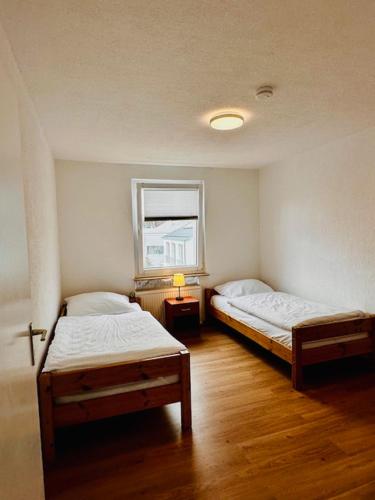 a room with two beds and a window at Ferienwohnung Trinh in Überlingen