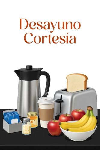 a table with a coffee maker and a bowl of fruit at Estudios Bacalar in Bacalar