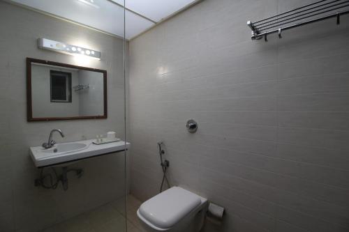 a bathroom with a toilet and a sink at The Byke Old Anchor Beach Resort & Spa in Cavelossim