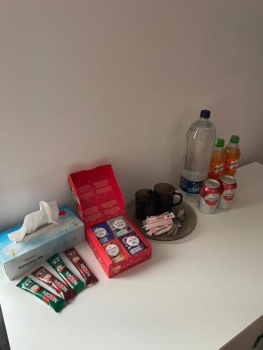 a counter with some food and drinks and a bottle of water at Rozelor Double Room in Timişoara