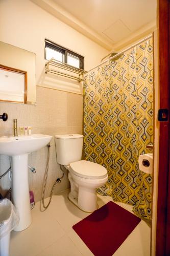 a bathroom with a toilet and a sink at Villa Lourdes Resort in Panglao Island