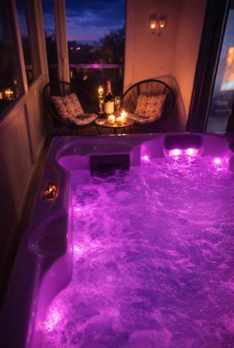 a hot tub with purple lights in a room at Kuća za odmor Petra in Erdut