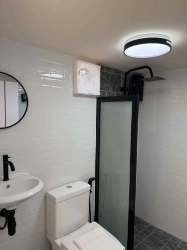a bathroom with a toilet and a sink at Baan Noah บ้านโนอาห์ in Lop Buri