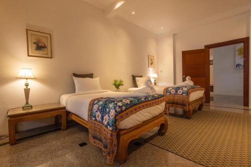 a hotel room with two beds in a room at Sirinary Villa - Natai Phangnga in Ban Na Tai
