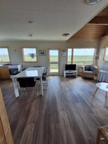 a large living room with a table and chairs at Mid-Sel mountain view lodge in Hella