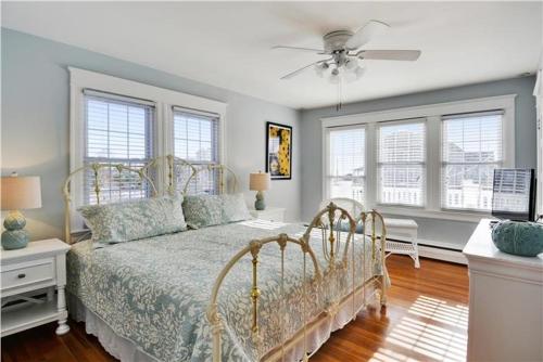 a bedroom with a bed and a ceiling fan at The Cape May Diamond in Cape May