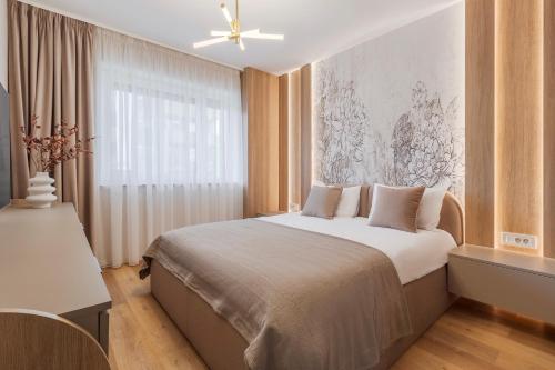 a bedroom with a large bed with a ceiling fan at Honey Oak Residence in Oradea