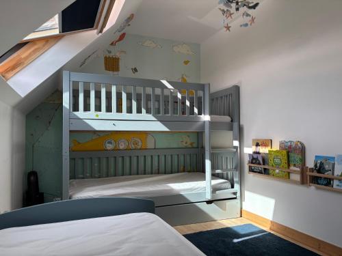 a childs bedroom with a bunk bed and stairs at Iroise in Combrit