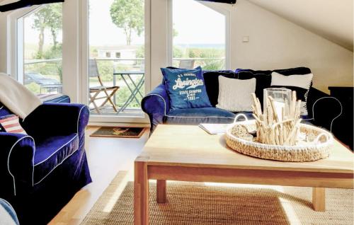 a living room with blue couches and a coffee table at Seebrise B in Süssau