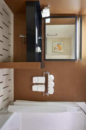 a bathroom with a sink and a mirror and towels at Fairfield Inn & Suites by Marriott Barrie in Barrie