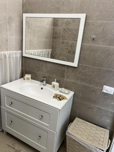 a bathroom with a sink and a mirror at Mamy Sweet Loft in Polignano a Mare