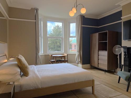 a bedroom with a large bed and a window at Melbury Rooms & Studios in Exeter