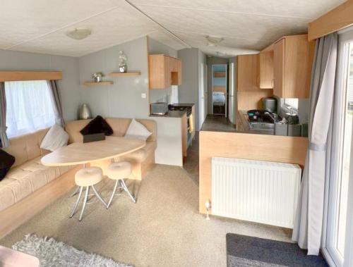 a living room with a couch and a table at 609 Sycamore Forest in Newquay