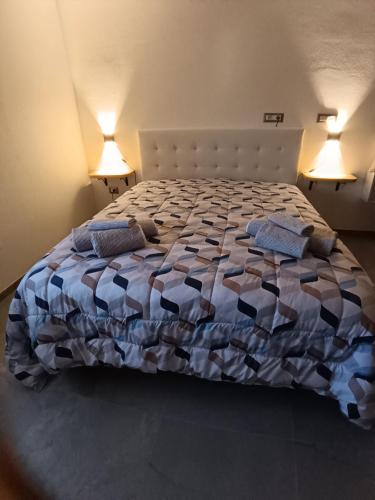 a bedroom with a bed with two pillows on it at Camera Valeria in Ossi
