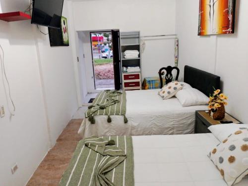 a bedroom with two beds and a tv in it at Rinconcito Veracruzano in Veracruz