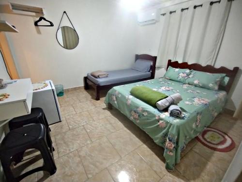 a bedroom with a bed and a chair in it at Edícula 1 em São Pedro in São Pedro