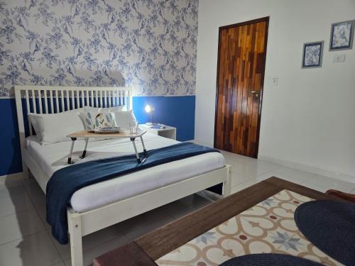 a bedroom with a bed and a table with a laptop on it at Flat 02 Carvalhos de Aldeia in Recife