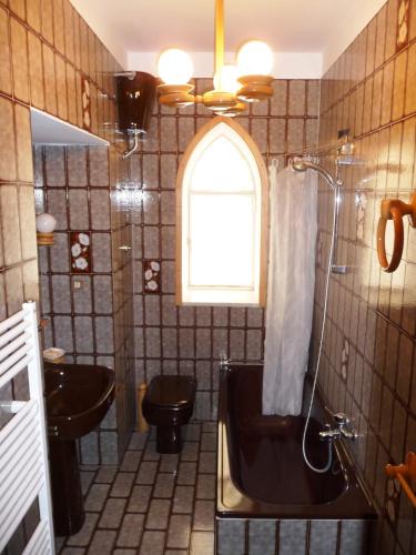 a bathroom with a tub and a toilet and a sink at Rosa Dei Venti in Amalfi