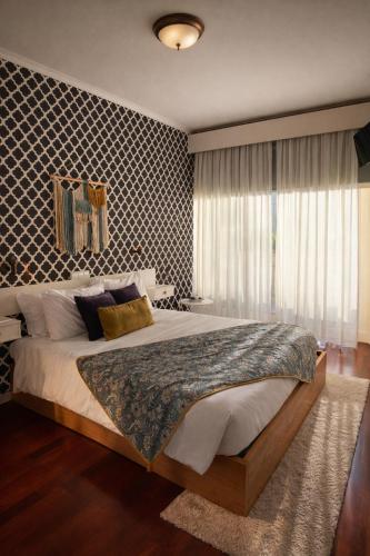 a bedroom with a large bed in a room at Vale de Azereiros Apartamentos - Alojamento no Gerês in Geres